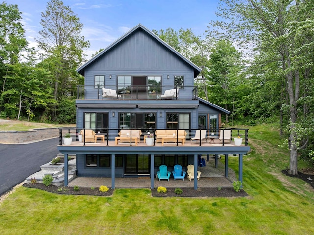 5 Michaels Way, Laconia, NH 03246 - rear view of property with a balcony, a lawn, a patio area, and board and batten siding