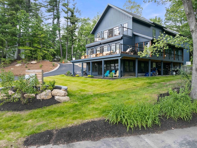 5 Michaels Way, Laconia, NH 03246 - back of property featuring board and batten siding, a yard, and a deck