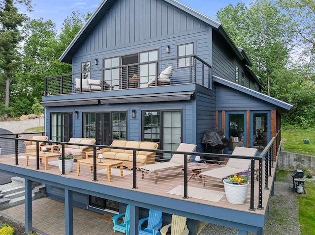 5 Michaels Way, Laconia, NH 03246 - back of property featuring a balcony, board and batten siding, an outdoor hangout area, and a deck