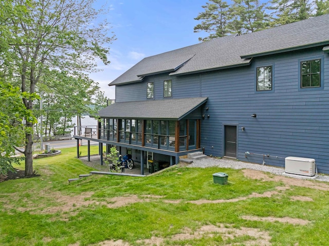 5 Michaels Way, Laconia, NH 03246 - rear view of property featuring a sunroom, roof with shingles, a lawn, and a wooden deck