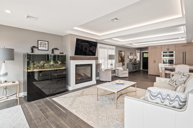 5 Michaels Way, Laconia, NH 03246 - living area featuring a raised ceiling, dark wood-type flooring, recessed lighting, and a glass covered fireplace