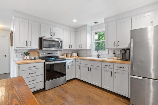 46 E Diane Dr, Keene, NH 03431 - kitchen with appliances with stainless steel finishes, butcher block countertops, backsplash, white cabinetry, and recessed lighting