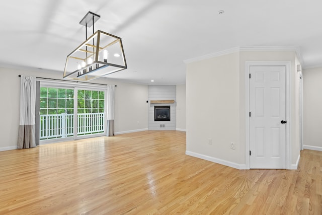 243 Drakeside Rd Unit 7, Hampton, NH 03842 - unfurnished living room with light wood-style flooring, crown molding, recessed lighting, a glass covered fireplace, and a chandelier