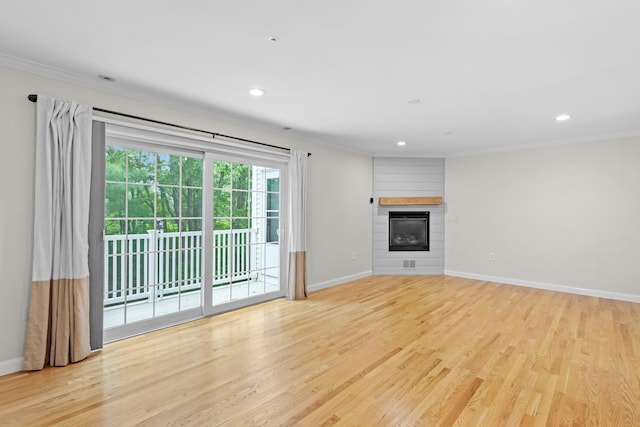 243 Drakeside Rd Unit 7, Hampton, NH 03842 - unfurnished living room featuring crown molding, light wood-style floors, recessed lighting, and a large fireplace