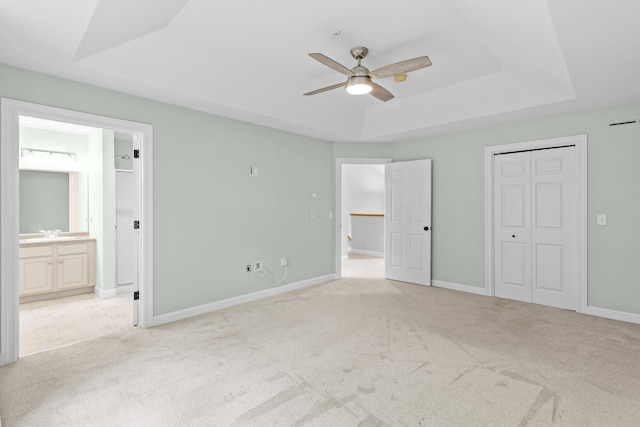 243 Drakeside Rd Unit 7, Hampton, NH 03842 - unfurnished bedroom featuring a raised ceiling, carpet flooring, ensuite bath, a ceiling fan, and a closet