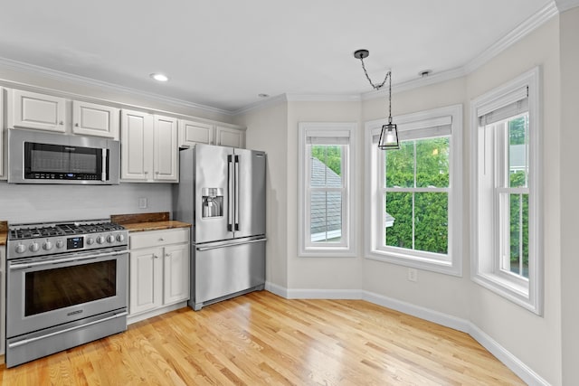 243 Drakeside Rd Unit 7, Hampton, NH 03842 - kitchen with appliances with stainless steel finishes, healthy amount of natural light, light wood-type flooring, ornamental molding, and recessed lighting