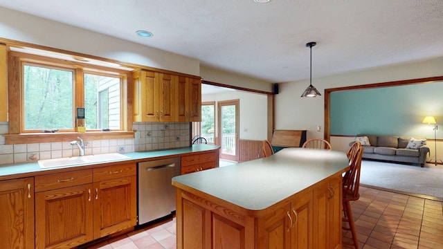 114 Snow Pond Rd, Concord, NH 03301 - kitchen featuring stainless steel dishwasher, brown cabinets, backsplash, and open floor plan