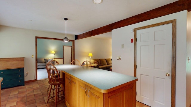114 Snow Pond Rd, Concord, NH 03301 - kitchen with open floor plan, a kitchen island, decorative light fixtures, light tile patterned floors, and a kitchen bar