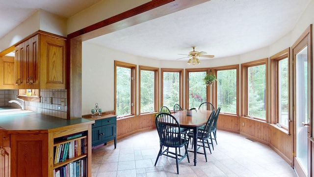 114 Snow Pond Rd, Concord, NH 03301 - dining area featuring ceiling fan, light stone finish floors, and wood walls