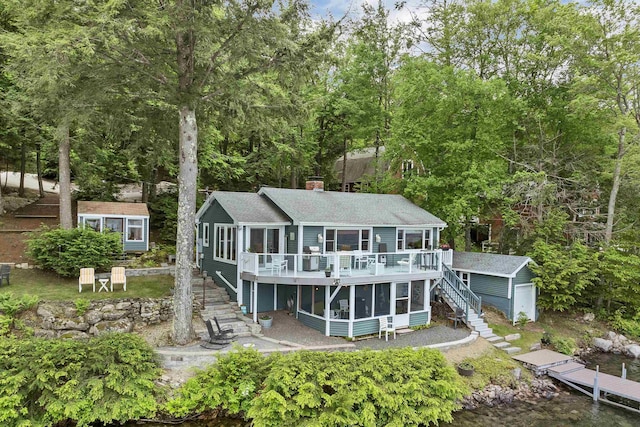 352 S Shore Rd, New Durham, NH 03855 - rear view of house with stairway, a shed, a sunroom, a deck, and a chimney