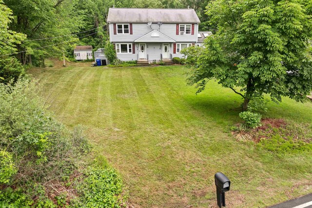 44A Windham Rd, Hudson, NH 03051 - colonial-style house featuring a front lawn and a storage unit