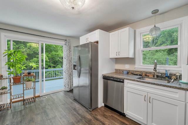 44A Windham Rd, Hudson, NH 03051 - kitchen featuring stainless steel appliances, white cabinetry, dark wood finished floors, dark stone counters, and hanging light fixtures