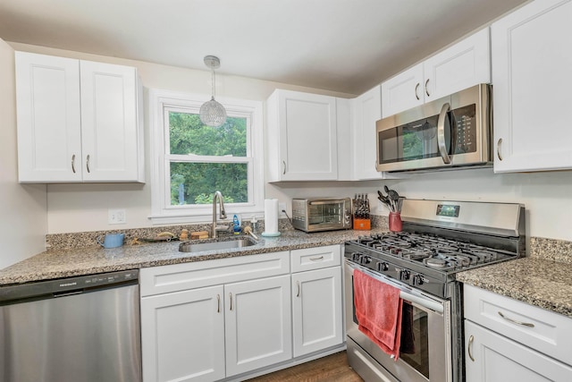 44A Windham Rd, Hudson, NH 03051 - kitchen featuring stainless steel appliances, white cabinets, and decorative light fixtures