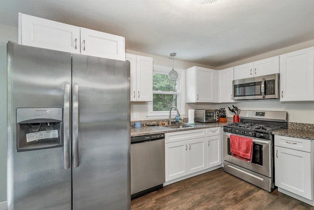 44A Windham Rd, Hudson, NH 03051 - kitchen with stainless steel appliances, white cabinets, dark wood-style floors, dark stone countertops, and decorative light fixtures