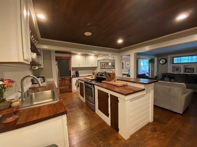 33 Newbury Heights Rd, Newbury, NH 03255 - kitchen with stainless steel appliances, wood counters, wooden ceiling, white cabinets, and open floor plan