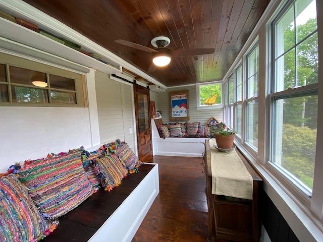 33 Newbury Heights Rd, Newbury, NH 03255 - sunroom / solarium featuring a barn door, wooden ceiling, and wood finished floors