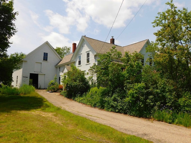 336 Main St, Wakefield, NH 03887 - rear view of property with a chimney, a lawn, and roof with shingles