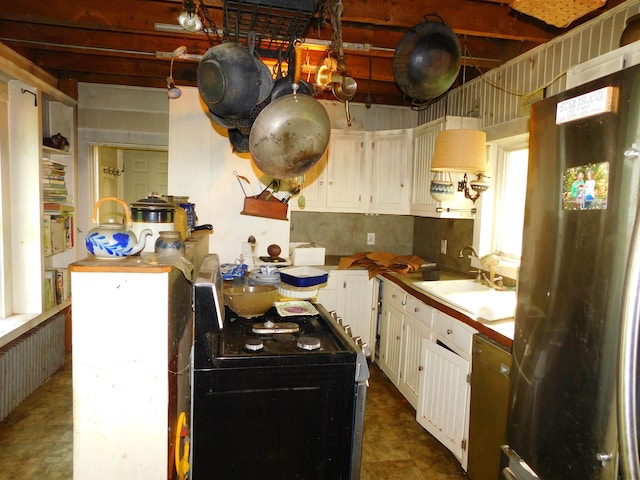 336 Main St, Wakefield, NH 03887 - kitchen featuring freestanding refrigerator, dishwashing machine, white cabinetry, range, and light countertops
