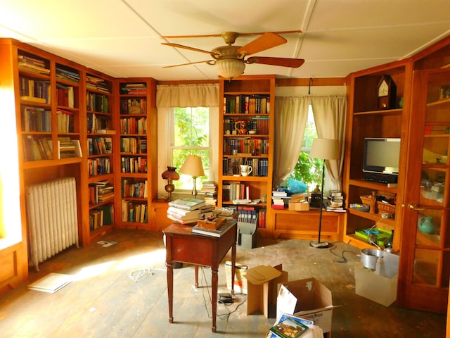 336 Main St, Wakefield, NH 03887 - sitting room featuring radiator, healthy amount of natural light, a ceiling fan, and bookshelves