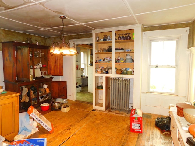 336 Main St, Wakefield, NH 03887 - dining area with radiator heating unit, wood finished floors, and a chandelier