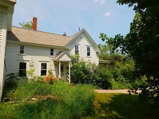 336 Main St, Wakefield, NH 03887 - view of front of property featuring a chimney and roof with shingles