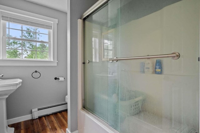 82 Robinhood Rd, Wakefield, NH 03830 - full bathroom featuring a baseboard radiator, wood finished floors, and shower / bath combination with glass door