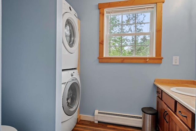 82 Robinhood Rd, Wakefield, NH 03830 - laundry room with a baseboard heating unit, estacked washer and dryer, and dark wood-type flooring