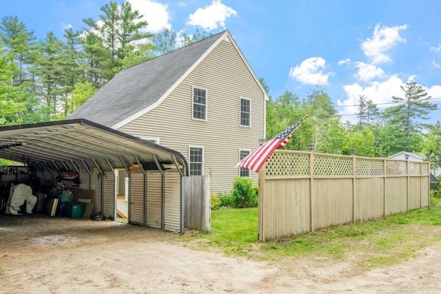 82 Robinhood Rd, Wakefield, NH 03830 - view of property exterior featuring driveway, a shingled roof, and a carport