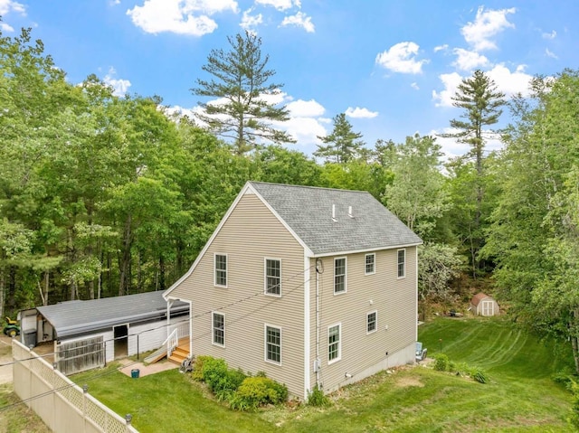 82 Robinhood Rd, Wakefield, NH 03830 - view of side of home featuring a shingled roof and a shed