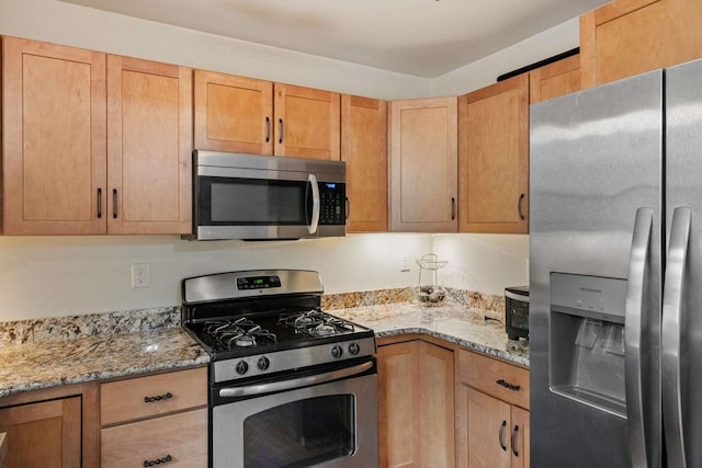 82 Robinhood Rd, Wakefield, NH 03830 - kitchen with stainless steel appliances, light stone counters, and light brown cabinets