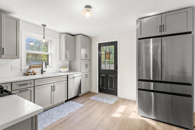 15 Wildflower Dr, Concord, NH 03303 - kitchen with stainless steel appliances, light wood-type flooring, gray cabinets, light countertops, and a textured ceiling