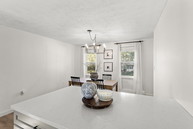 15 Wildflower Dr, Concord, NH 03303 - dining area featuring a chandelier, a textured ceiling, and wood finished floors