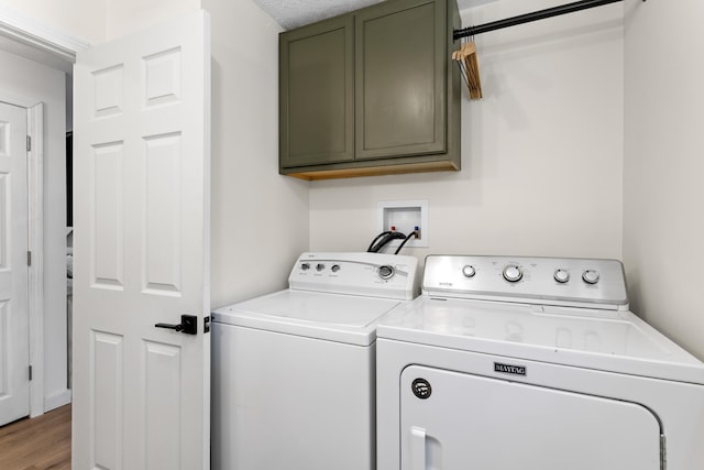15 Wildflower Dr, Concord, NH 03303 - laundry area with cabinet space, washing machine and dryer, and wood finished floors