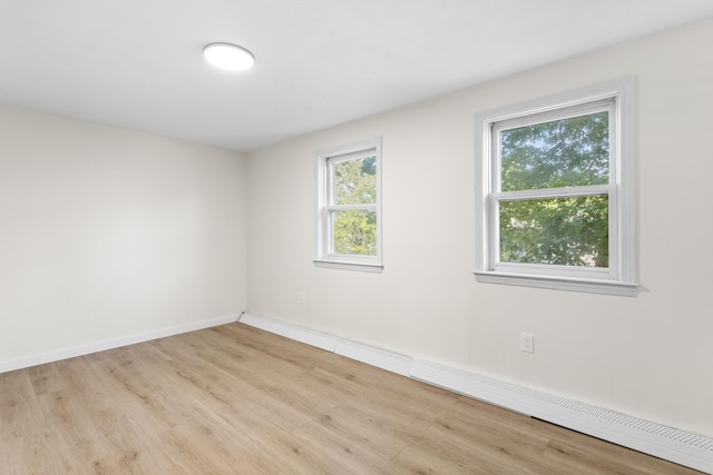 15 Wildflower Dr, Concord, NH 03303 - spare room featuring wood finished floors and a baseboard radiator
