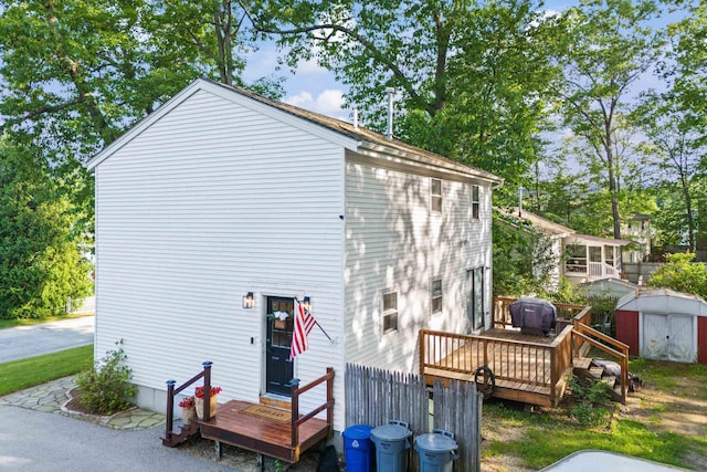 15 Wildflower Dr, Concord, NH 03303 - rear view of property featuring a deck and a shed