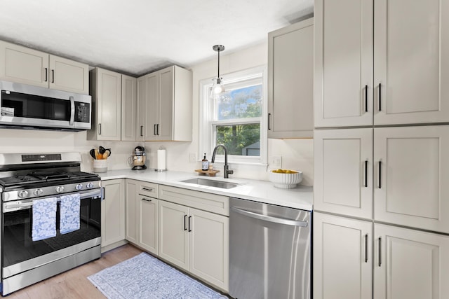 15 Wildflower Dr, Concord, NH 03303 - kitchen with appliances with stainless steel finishes, light countertops, light wood-style floors, and pendant lighting