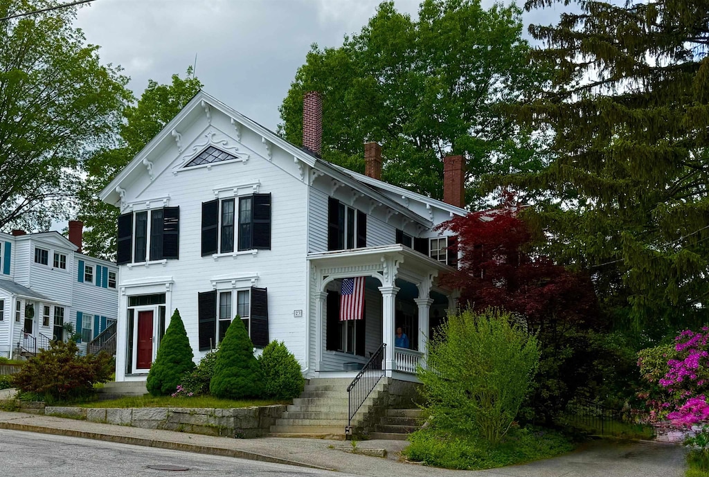 23 Prospect St, Somersworth, NH 03878 - italianate-style house featuring a chimney and covered porch