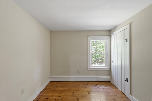 27 Mason Rd, Brookline, NH 03033 - unfurnished bedroom with hardwood / wood-style flooring, a baseboard radiator, and a closet