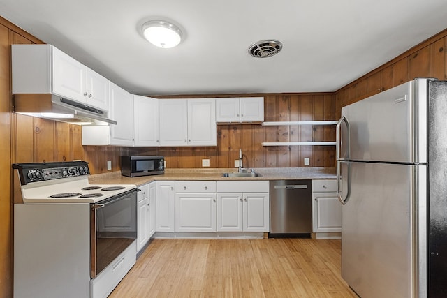 27 Mason Rd, Brookline, NH 03033 - kitchen with stainless steel appliances, under cabinet range hood, white cabinets, light wood-style floors, and light countertops