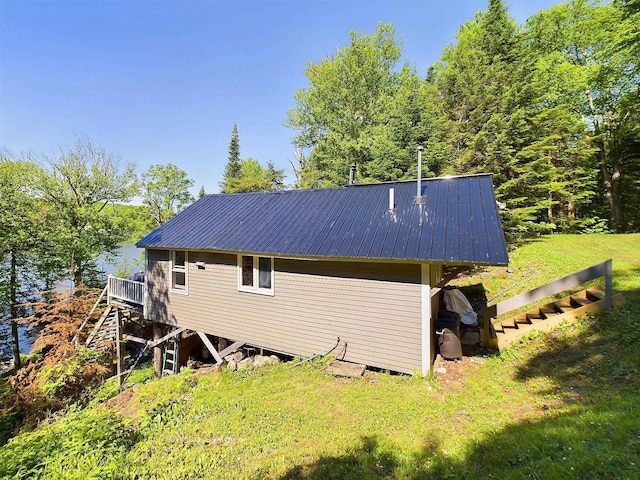312 Roy Rd, Stewartstown, NH 03576 - view of property exterior featuring a metal roof, stairway, a lawn, and a wooden deck