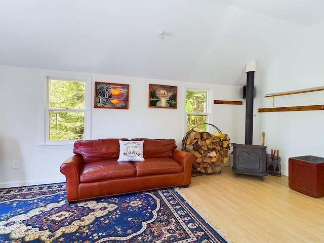 312 Roy Rd, Stewartstown, NH 03576 - living area featuring a wood stove, healthy amount of natural light, wood finished floors, and lofted ceiling