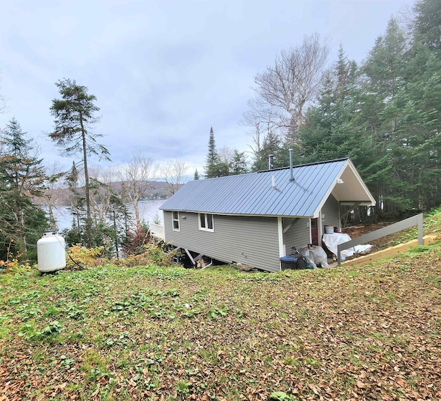 312 Roy Rd, Stewartstown, NH 03576 - view of home's exterior with a metal roof and a water view