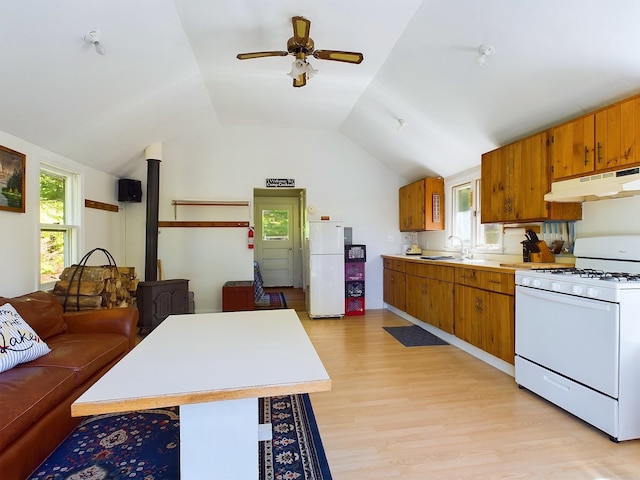 312 Roy Rd, Stewartstown, NH 03576 - kitchen with white appliances, under cabinet range hood, light countertops, brown cabinetry, and lofted ceiling