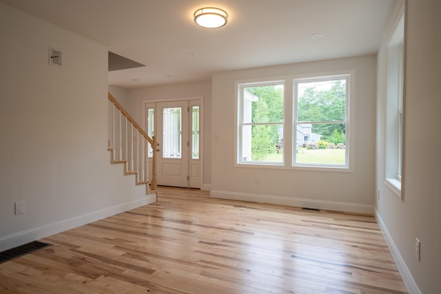 51 Spruce Rd, Middleton, NH 03887 - foyer with light wood-style floors and stairway