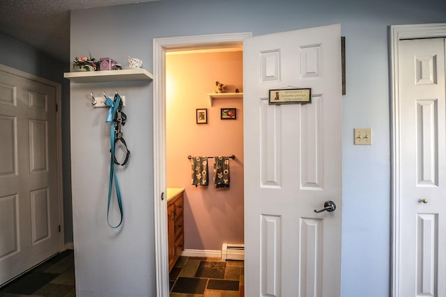 19 Shelburne Rd Unit 19, Merrimack, NH 03054 - hall featuring a baseboard heating unit and baseboards