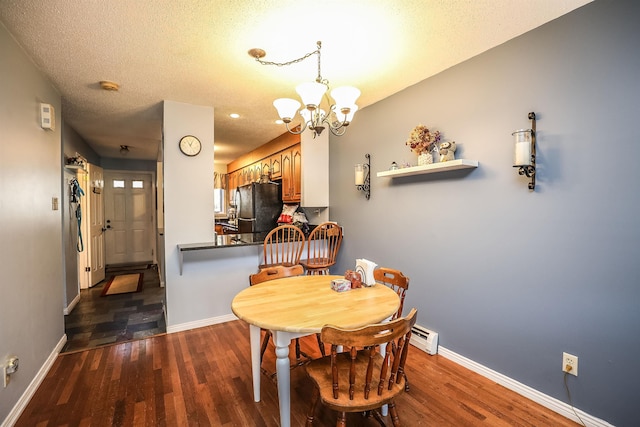 19 Shelburne Rd Unit 19, Merrimack, NH 03054 - dining area featuring a chandelier, dark wood-style flooring, baseboard heating, and a textured ceiling