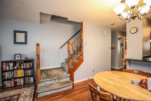 19 Shelburne Rd Unit 19, Merrimack, NH 03054 - dining area with stairway, wood finished floors, a chandelier, and a textured ceiling