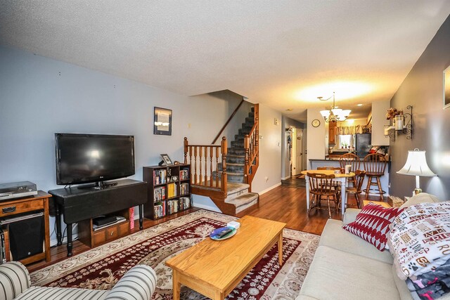 19 Shelburne Rd Unit 19, Merrimack, NH 03054 - living room featuring a chandelier, stairway, wood finished floors, and a textured ceiling
