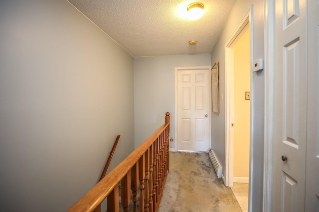 19 Shelburne Rd Unit 19, Merrimack, NH 03054 - hall with an upstairs landing, a baseboard heating unit, light colored carpet, and a textured ceiling