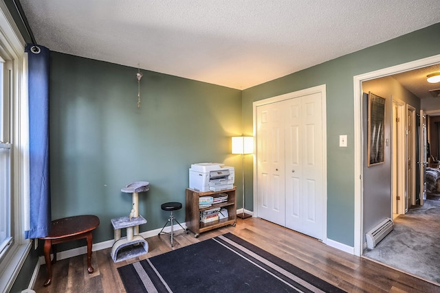 19 Shelburne Rd Unit 19, Merrimack, NH 03054 - sitting room featuring baseboard heating, wood finished floors, and a textured ceiling
